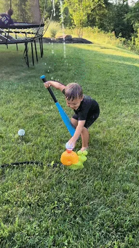kids playing with sprinkler